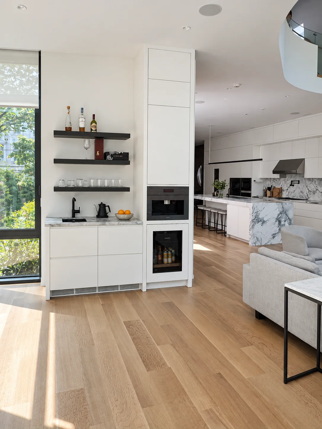 White beverage cabinetry and open shelves beside the main kitchen