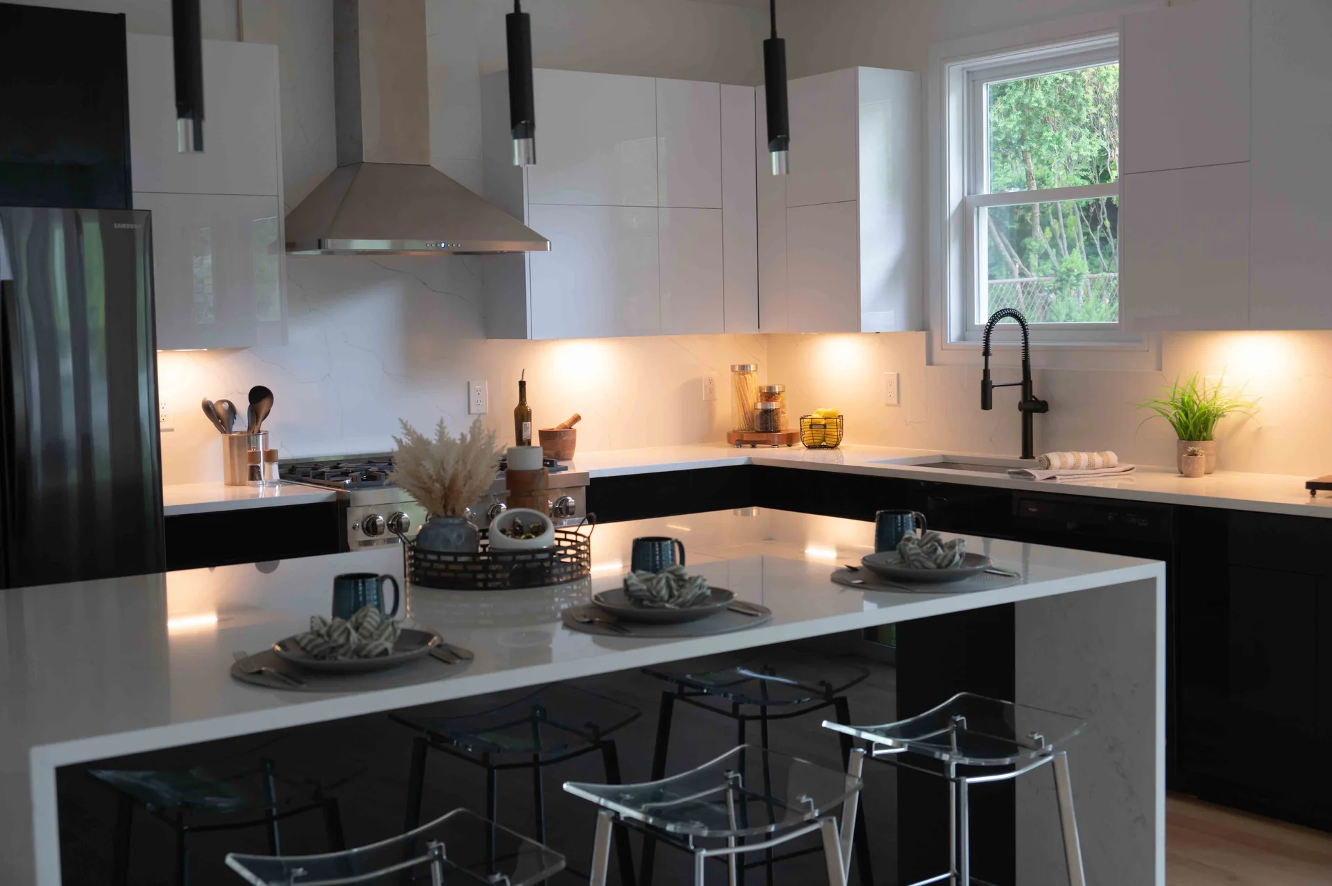 White island, black base cabinetry and white upper cabinets